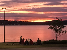 grainy photo thy Word is Lamp unto my Feet. Warners Bay Sunset People gathered and seated 