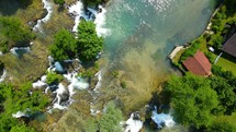 Aerial shot drone descends with camera down over water in middle of Rastoke, Slunj, Croatia