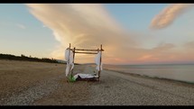 Canopy bed on the beach at dawn 