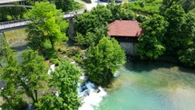 Aerial shot drone flies low backwards over lakes and cascades of Rastoke, Slunj, Croatia