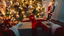 Santa Claus deliver a Christmas box presents under the tree pov shot