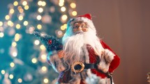 Santa Clause Toy Against Christmas Tree in night