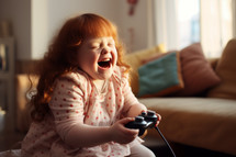 AI generative images. Happy adorable redhead girl with Downs syndrome holding joystick and playing video game