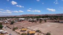 Aerial shot drone flies up and away from green space in middle of Atacama desert