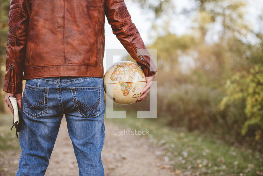 man with a globe and Bible 