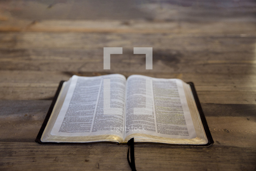 open Bible on a wood background 