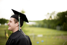 male graduate in cap and gown 