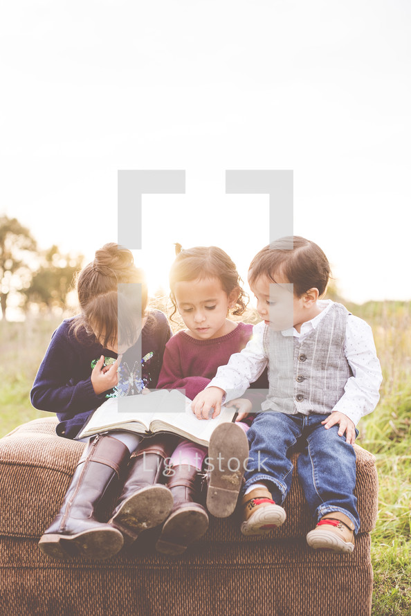 kids reading a Bible together 