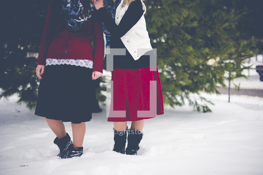 women standing outdoors in snow 