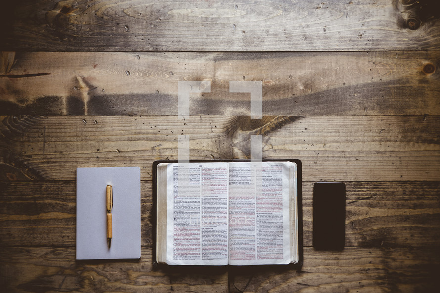 pen, journal, spine, and Bible for a personal Bible study 