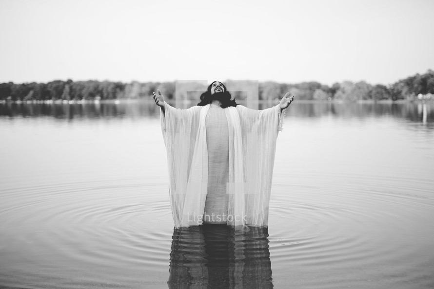 Jesus standing in water with outstretched arms 