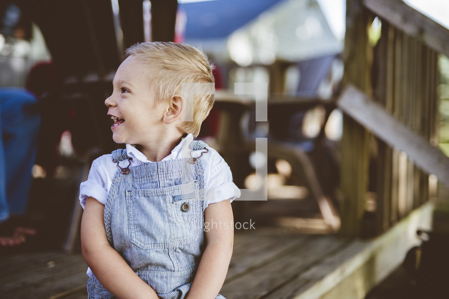 toddler boy on a deck 