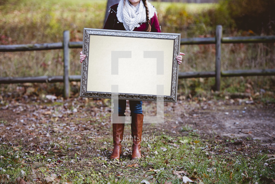woman holding a blank sign 