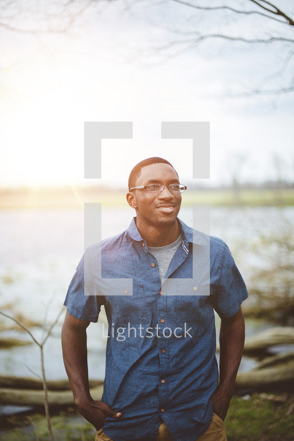 portrait of an African American male standing outdoors 