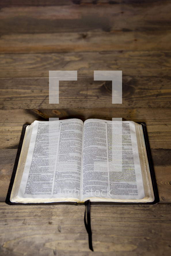 opened Bible on a wood background 