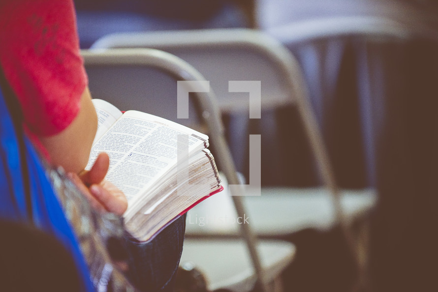 Bibles in laps during a worship service 