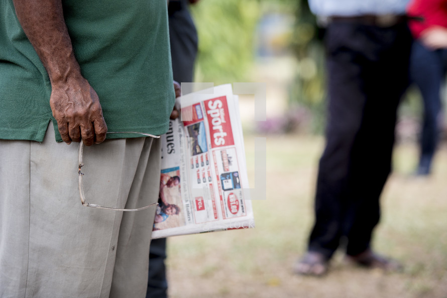 man holding a newspaper 