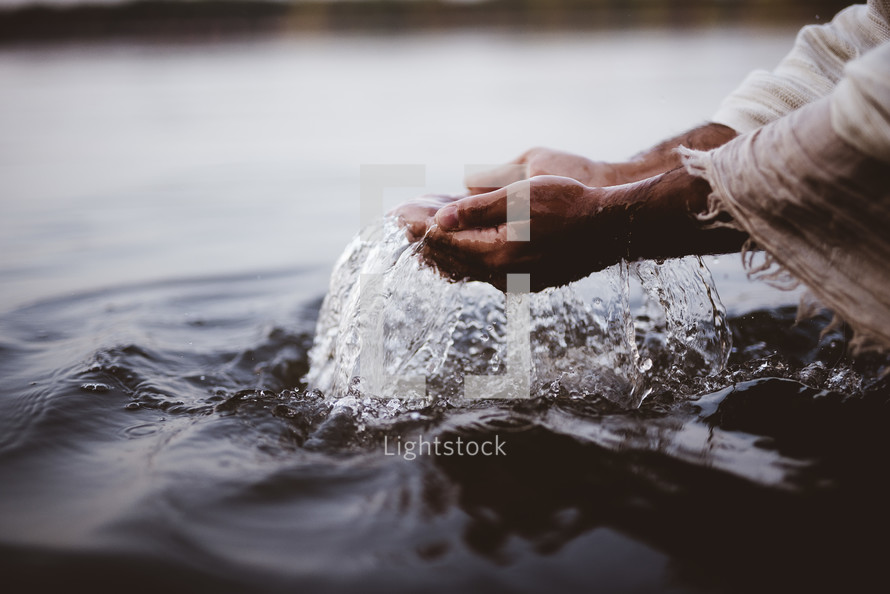 Jesus standing in water with cupped hands 