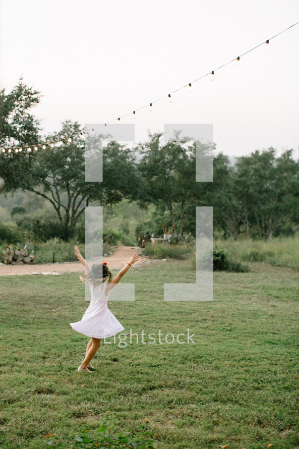 girl dancing in the grass 