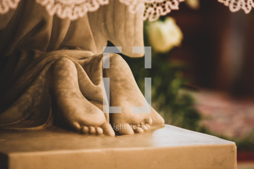 kneeling feet of a statue 