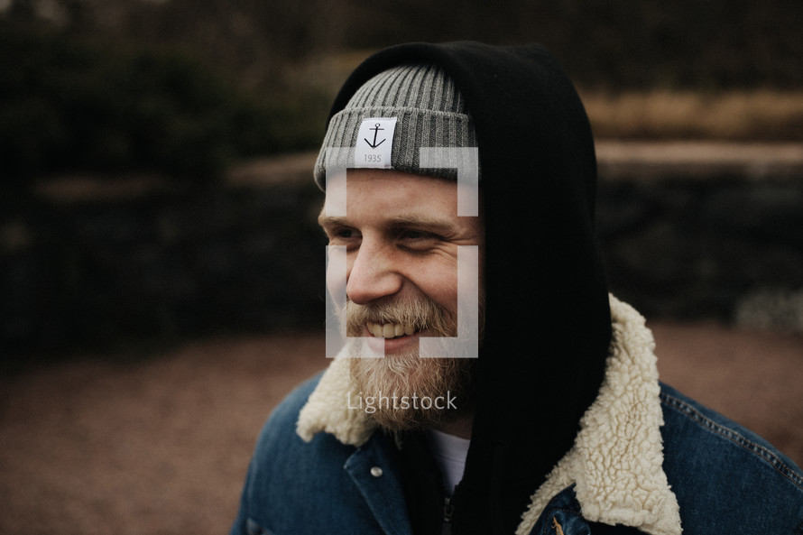 smiling bearded man in a beanie 