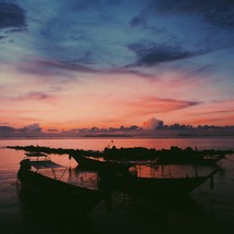 boats in the water at sunset 
