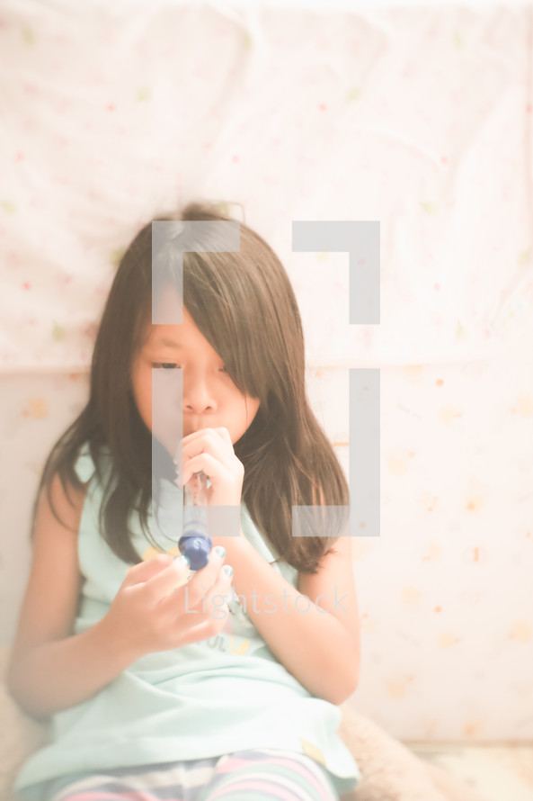 a girl playing a toy flute 