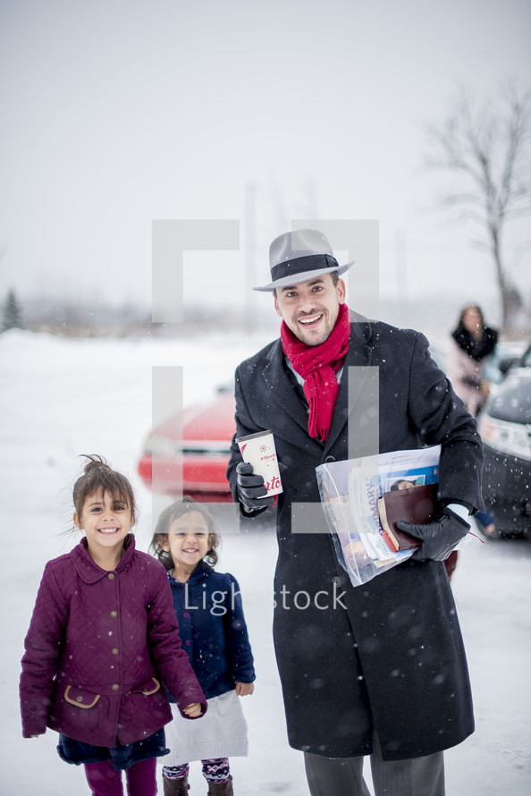 a father and his daughters headed to church in the snow 