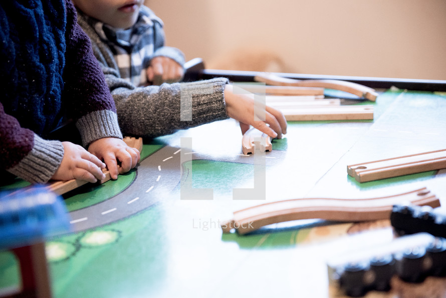 kids playing with a toy train set 