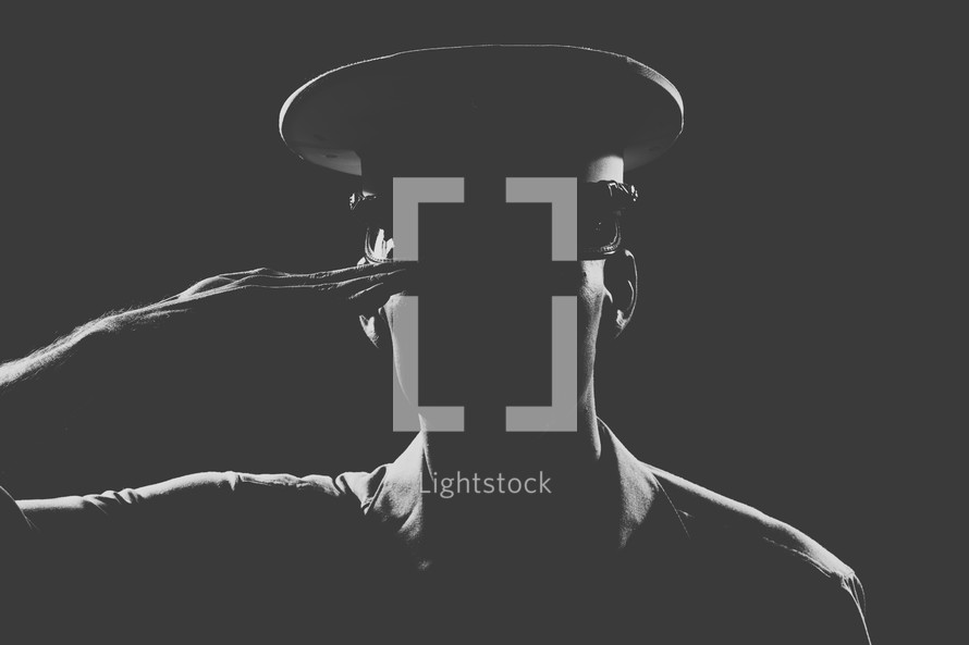Soldier in uniform saluting.