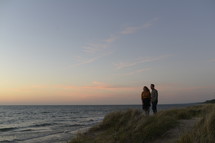 couple standing on a beach in the evening in fall 