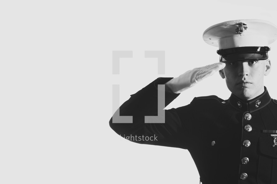 Marine in uniform saluting.