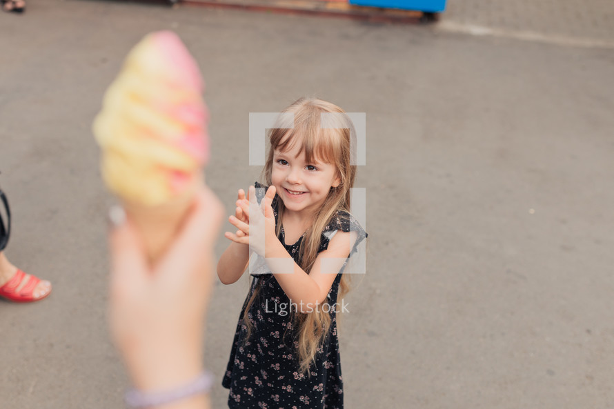 excited child getting an ice cream cone 