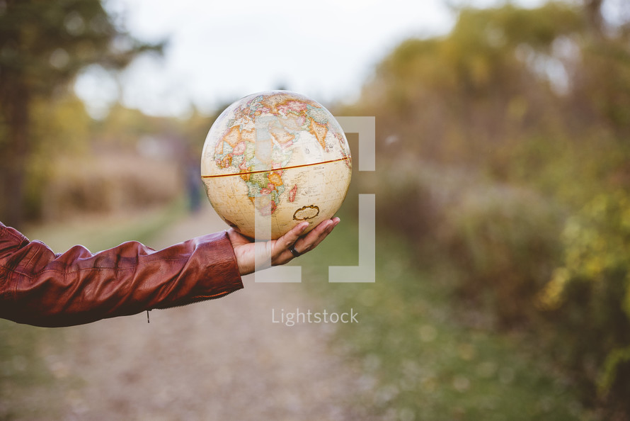 outstretched arm with a globe 
