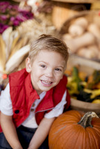 smiling boy with a pumpkin 