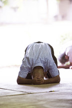 a man kneeling in surrender 
