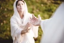 Jesus reaching towards a woman 