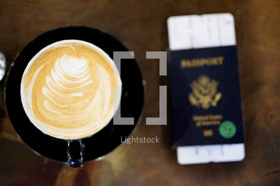 coffee cup, passport, and plane ticket 
