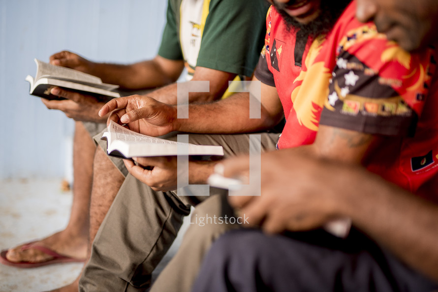 group of men reading Bibles 
