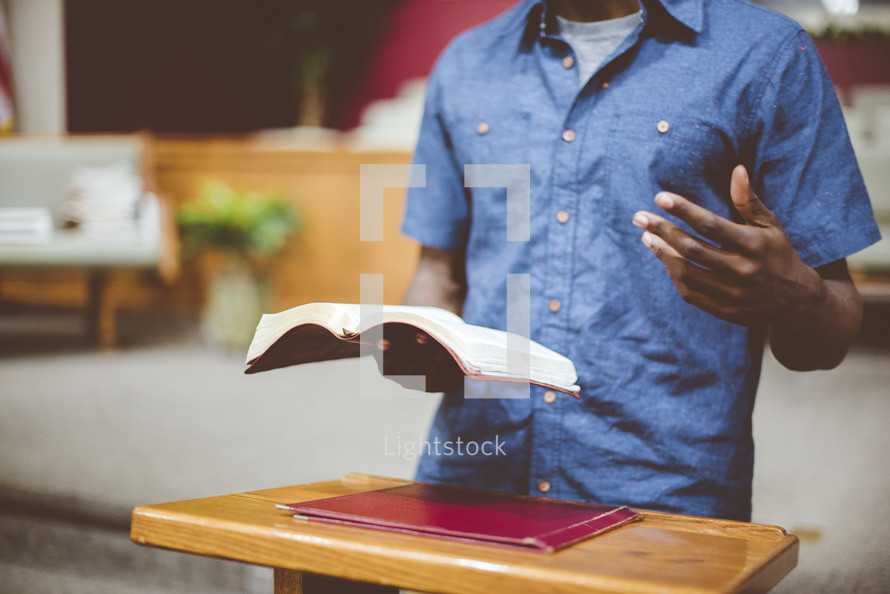 a man reading from a Bible during a worship service 