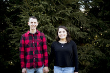 couple in a Christmas tree lot 