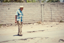 elderly man crossing the street