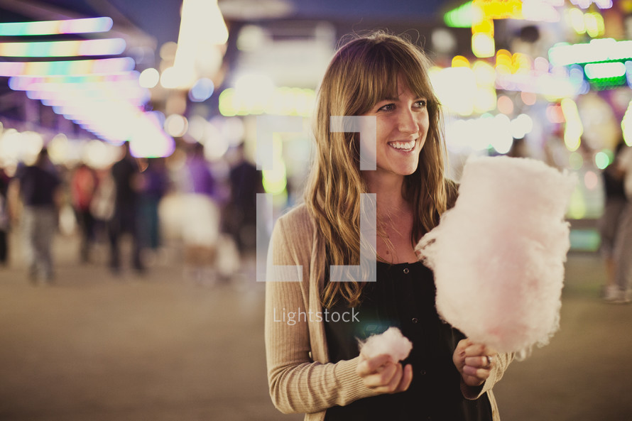 Woman with cotton candy at carnival