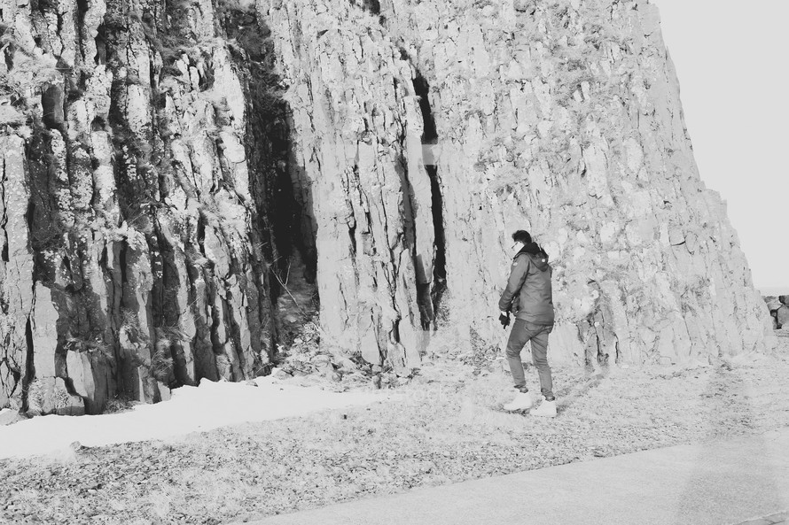 a man approaching a steep cliff 