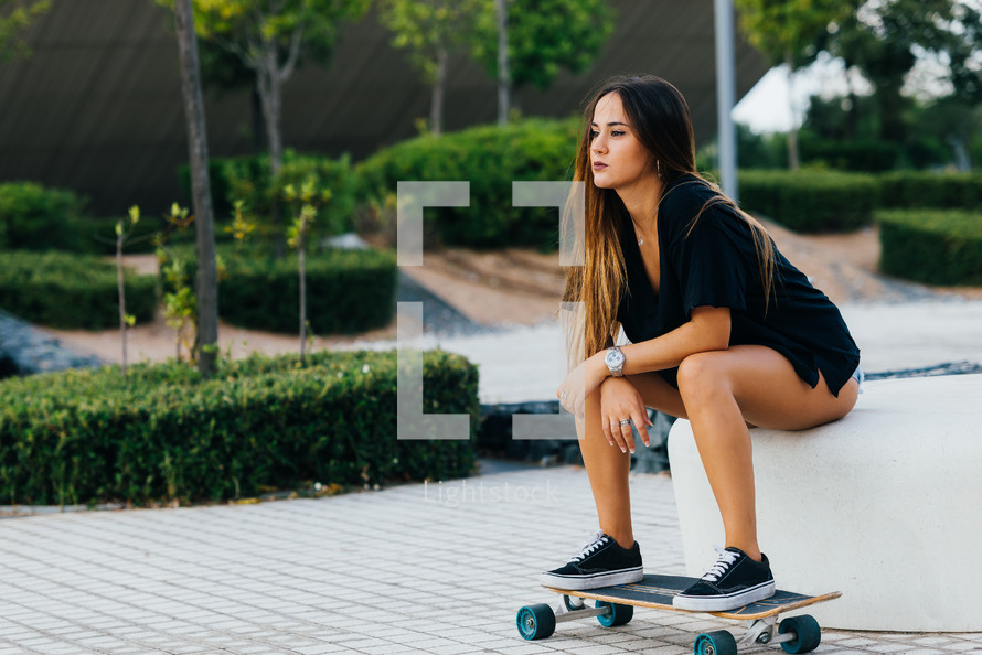 young woman posing on a skateboard 