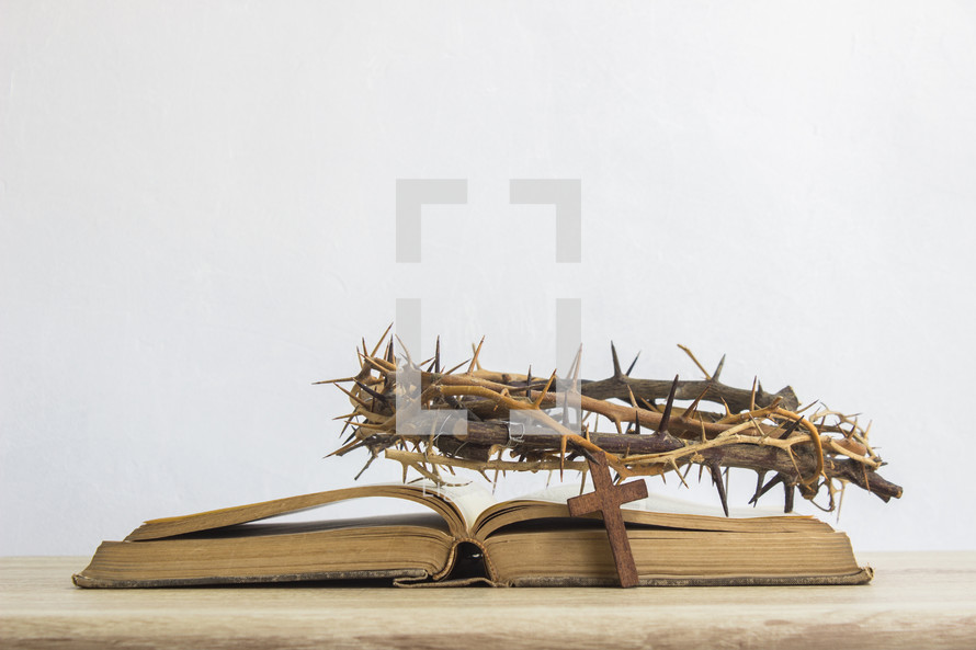 crown of thorns, Bible and cross on a desk 