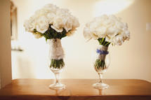bridal bouquets in wine glasses