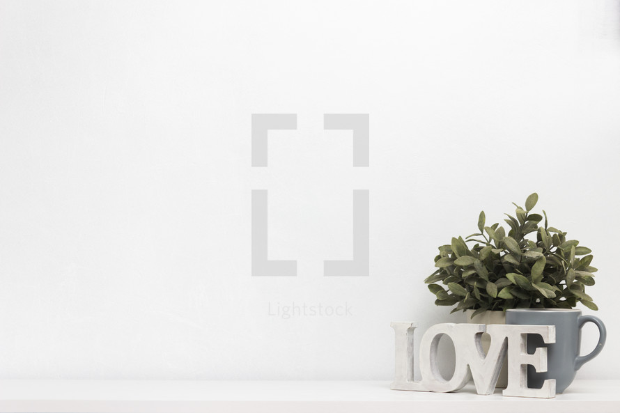Love sign, houseplant, and mug 