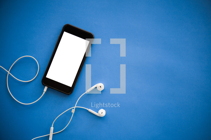 cellphone and earbuds on a blue background 