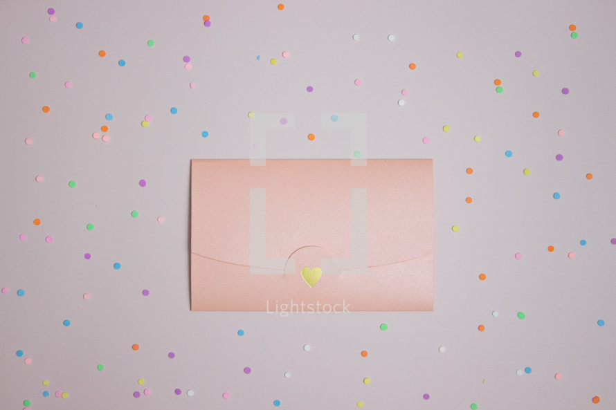 Pink card on confetti background